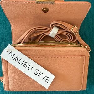 Small crossbody bag with lots of compartments and slots for cards.